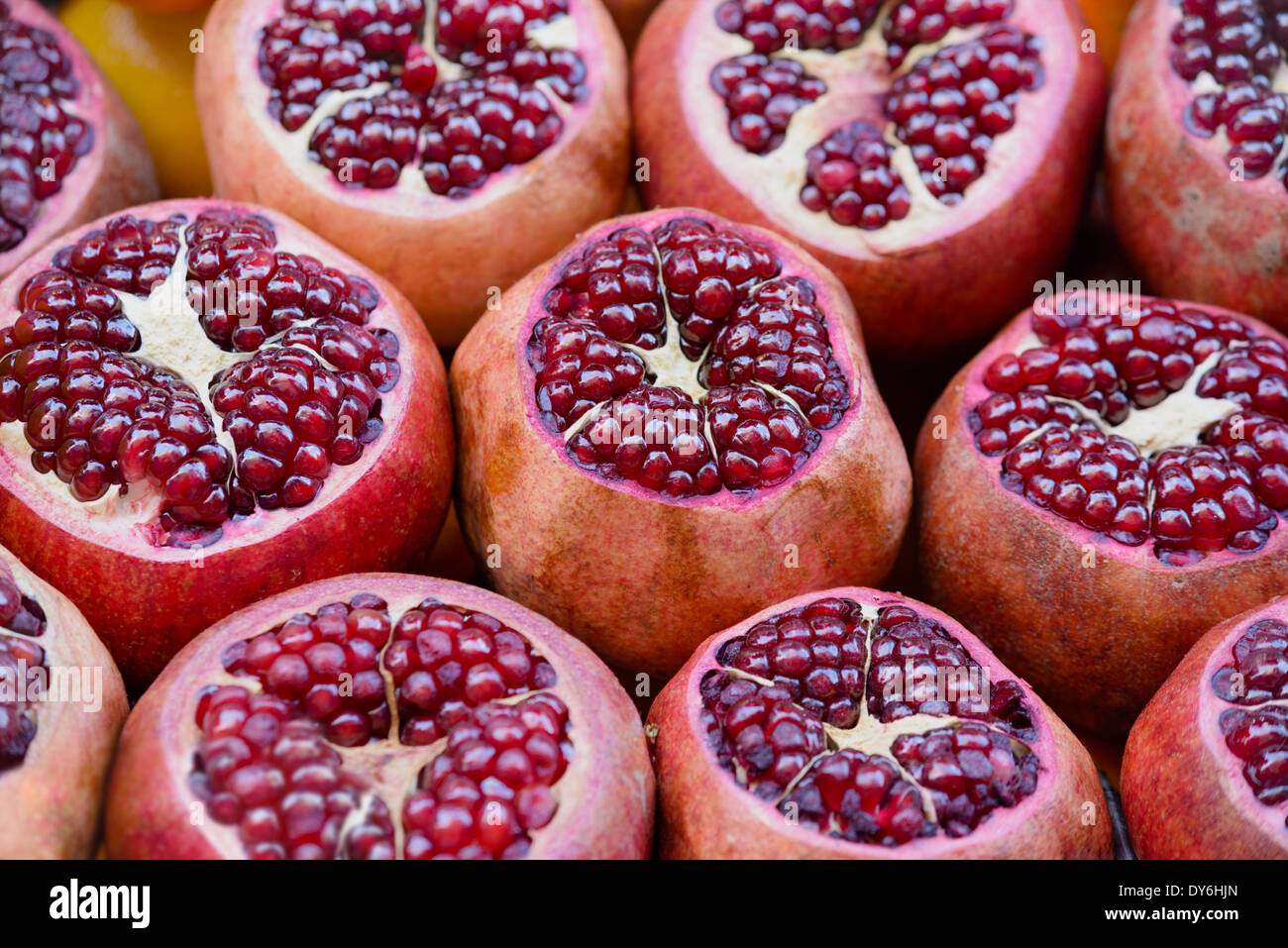Backgrounds and textures: fresh pomegranates on a street vendor`s counter, food abstract Stock Photo